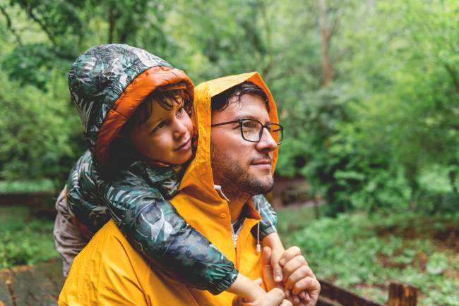 Father and son wearing rain jackets.