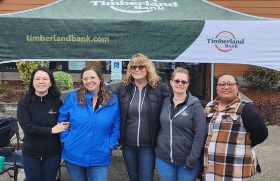 Smiling volunteers at a Timberland Bank Community Shred Day in Puyallup, WA.