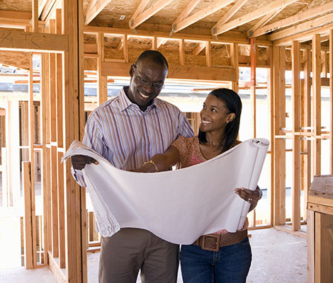 Husband and wife going over plans for new house