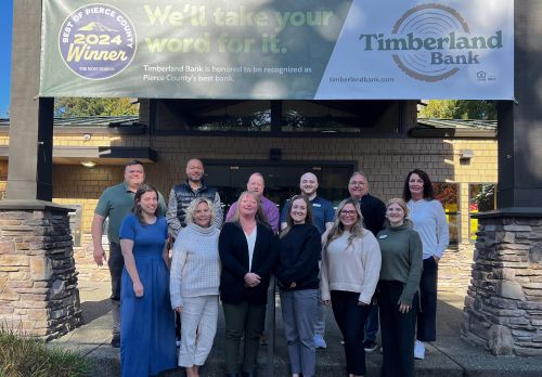 Timberland Bank employees posing in front of Gig Harbor branch.