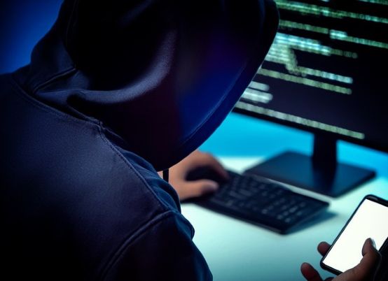 Scammer on computer and mobile phone