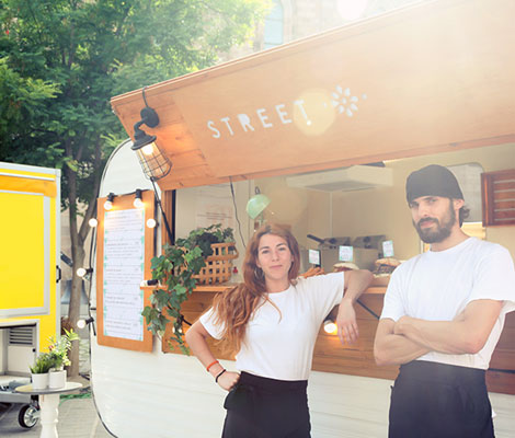 business owners in front of their food truck