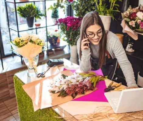 Woman working at a flower shop.