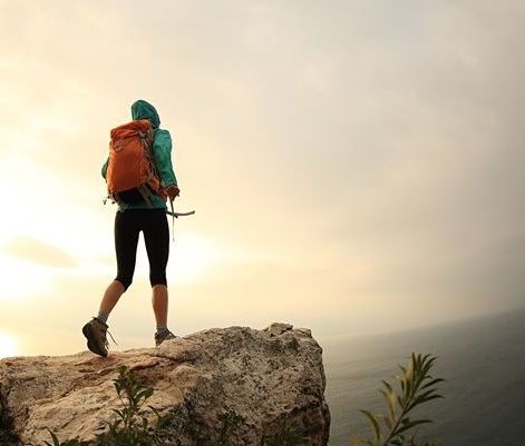 runner on top of a mountain looking at the ocean