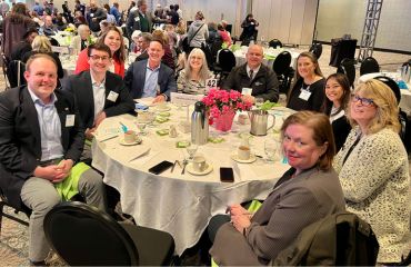 Timberland Bank employees sitting at a table during a charity luncheon.