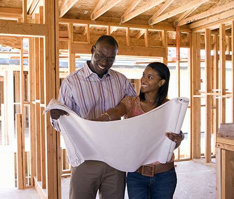 couple looking at construction plans