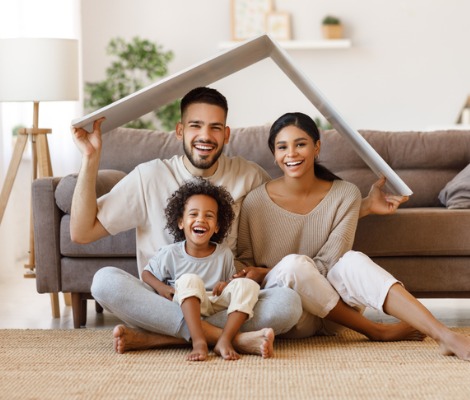 family under fake roof in living room
