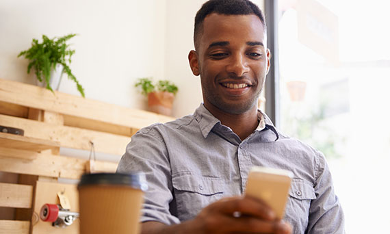 Man using phone in restaurant