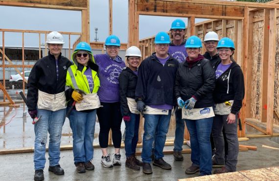 Smiling Timberland employees volunteering with Habitat for Humanity.