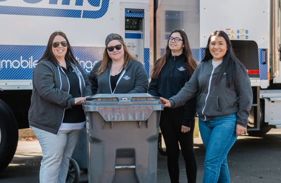 Smiling volunteers at a Timberland Bank Community Shred Day.