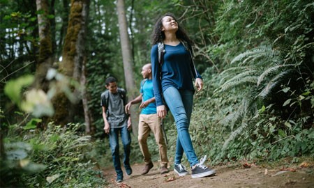 girl smiling and taking a hike with friends