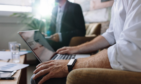 Man on his laptop in a meeting