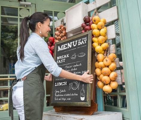 small business owner setting out a menu