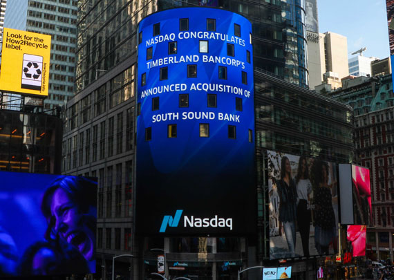 NASDAQ board in Times Square reads "NASDAQ congratulates Timberland Bancorp's announced acquisition of South Sound Bank"