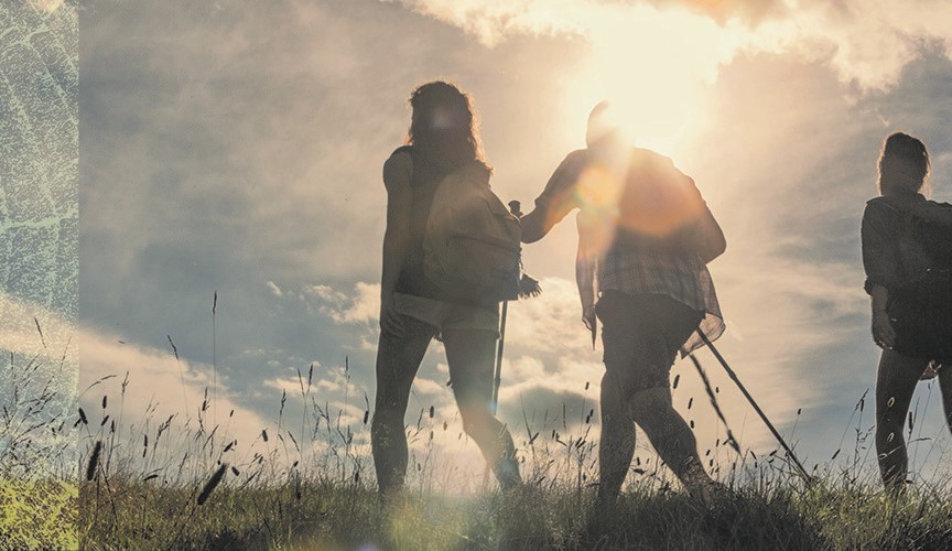 People hiking in a field.