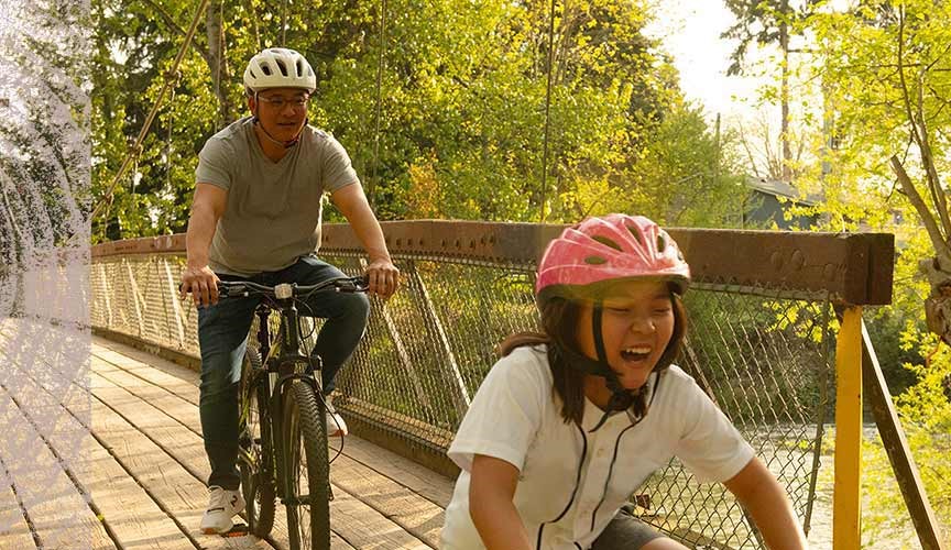 Steve Kim bike riding with kids.