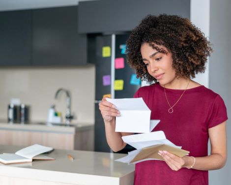 woman reading her mail at home