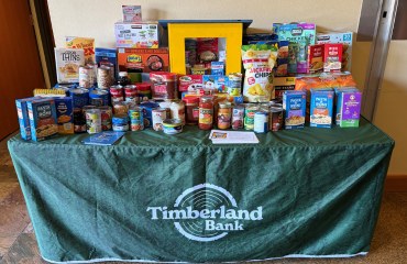 Table covered in food donations at the Timberland Bank branch in Gig Harbor. 