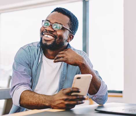 person laughing while using mobile phone