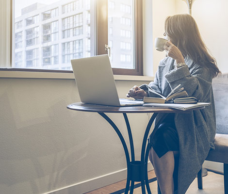 woman on her laptop drinking coffee