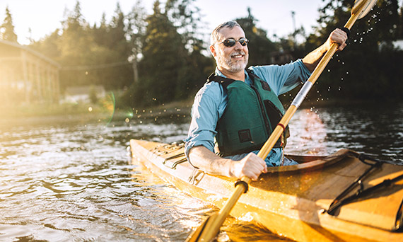 Man riding in kayak.