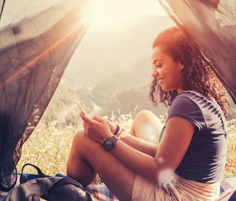 woman in a tent on her phone