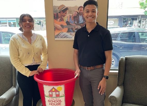 Timberland Bank employees in front of the Little Red School House donation bin.
