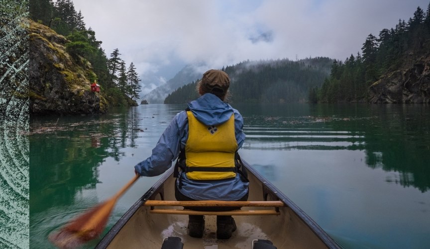 Person on a canoe paddling in nature. 