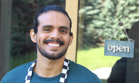 business owner smiling in front of his business