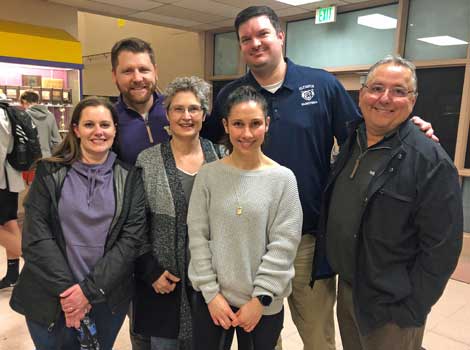Matt Hargrave and employees from the lending team pose for a photo at a basketball game in Olympia