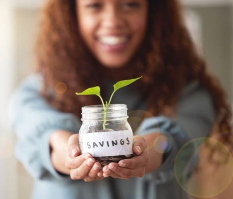 Woman holding savings jar.
