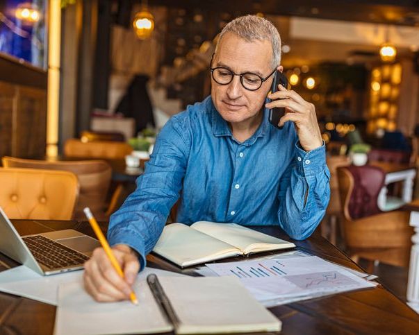 Small business owner on the phone and writing