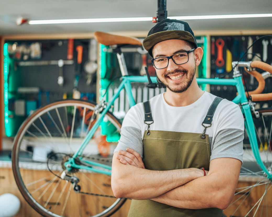 bicycle shop owner standing with arms crossed