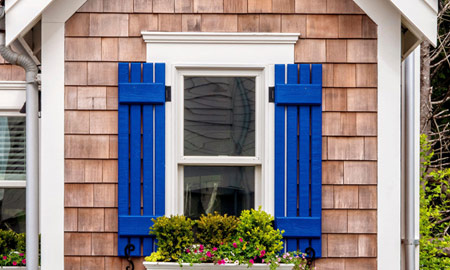 house with wood shingles and blue shutters